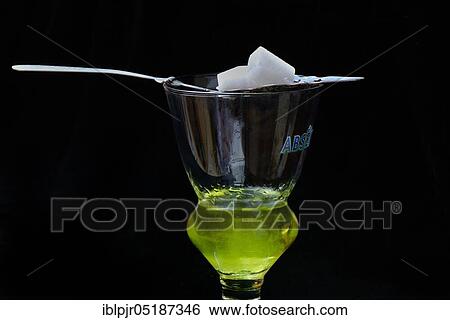 Glass of absinthe with absinthe spoon and sugar cubes, Green Fairy View Large Photo Image Stock Photograph - Glass of absinthe with absinthe spoon and sugar cubes, Green Fairy. Fotosearch