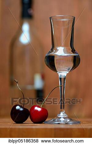Glass of cherry brandy with cherries View Large Photo Image Stock Photo - Glass of cherry brandy with cherries. Fotosearch