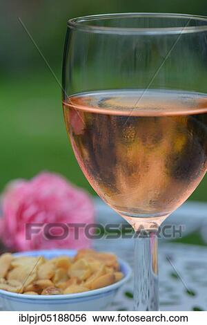 Glass of rose wine and small bowl with peanuts, rose wine View Large Photo Image Stock Photograph - Glass of rose wine and small bowl with peanuts, rose wine. Fotosearch