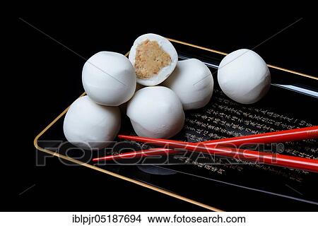 Glutinous rice balls with peanut filling, on a bowl with chopsticks View Large Photo Image Picture - Glutinous rice balls with peanut filling, on a bowl with chopsticks. Fotosearch