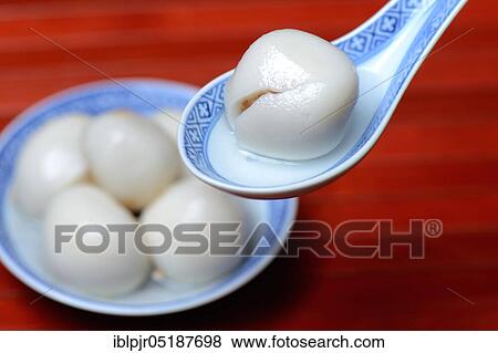 Stock Photo - Glutinous rice balls with peanut filling in bowl and spoon. Fotosearch