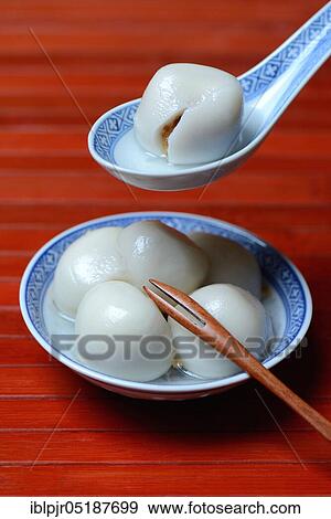 Stock Photo - Glutinous rice balls with peanut filling in bowl and spoon. Fotosearch