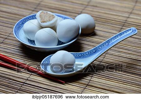 Stock Photograph - Glutinous rice balls with peanut filling in bowl and spoon. Fotosearch