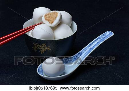 Stock Photography - Glutinous rice balls with peanut filling, on bowl and spoon. Fotosearch