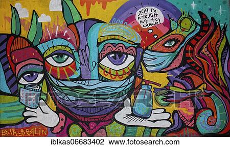 Stock Image - Graffiti, colourful face with mouth mask, paper roll and disinfectant, streetart for the Corona pandemic, Düsseldorf, North Rhine-Westphalia, Germany, Europe. Fotosearch