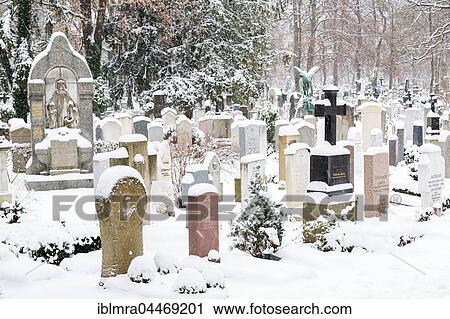 Grave stones at snowy cemetery in winter, Ostfriedhof, Munich, Bavaria, Germany, Europe View Large Photo Image Stock Image - Grave stones at snowy cemetery in winter, Ostfriedhof, Munich, Bavaria, Germany, Europe. Fotosearch