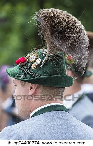 Picture - Green hat with brim, large Gamsbart, badges, green hat bands, gray costume jacket, men's costume, Oktoberfest, Munich, Upper Bavaria, Bavaria, Germany, Europe. Fotosearch