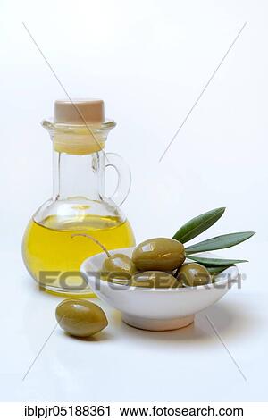 Stock Image - Green olives in shell and bottle olive oil, Olea spec., Chalkidiki olives, Greece, Europe. Fotosearch