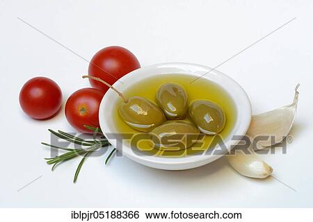 Green olives in shell with olive oil, olea spec., Chalkidiki olives, tomatoes, rosemary, garlic, Mediterranean, Mediterranean diet View Large Photo Image Stock Photograph - Green olives in shell with olive oil, olea spec., Chalkidiki olives, tomatoes, rosemary, garlic, Mediterranean, Mediterranean diet. Fotosearch