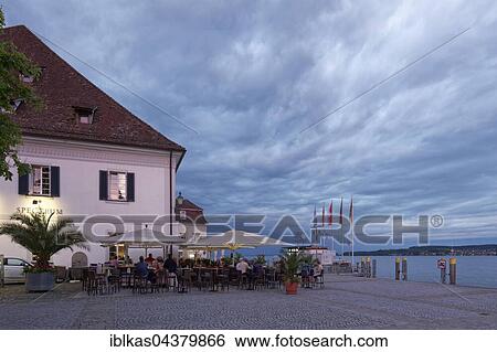 Gret, market hall with outdoor seating at the lakeside promenade in the evening, Überlingen, Lake Constance, Baden-Württemberg, Germany, Europe View Large Photo Image Stock Photograph - Gret, market hall with outdoor seating at the lakeside promenade in the evening, Überlingen, Lake Constance, Baden-Württemberg, Germany, Europe. Fotosearch