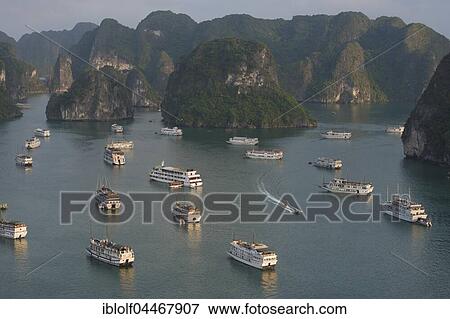 Halong Bay with boats, limestone cliffs, the Gulf of Tonkin, Halong, North Vietnam, Vietnam, Asia View Large Photo Image Stock Photo - Halong Bay with boats, limestone cliffs, the Gulf of Tonkin, Halong, North Vietnam, Vietnam, Asia. Fotosearch