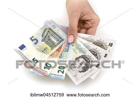 Hand holding money notes, fan with euro and pound sterling View Large Photo Image Stock Photo - Hand holding money notes, fan with euro and pound sterling. Fotosearch