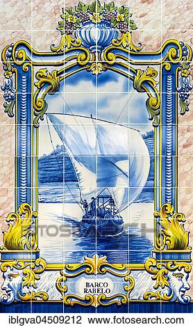 Stock Image - Hand-painted azulejo, ceramic tile with motif Rabelo boat for the transport of wine barrels, wine region Alto Douro, Pinhao, Portugal, Europe. Fotosearch