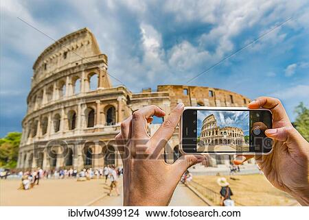 Picture - Hands of tourist photographing the Colosseum with smartphone, iPhone, Rome, Lazio, Italy, Europe. Fotosearch