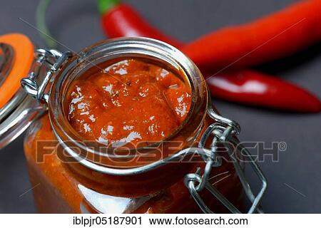Stock Image - Harissa, spice paste from chili. Fotosearch