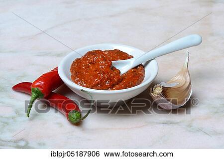 Stock Photograph - Harissa, spice paste from chili, garlic, garlic clove. Fotosearch
