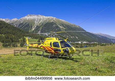 Stock Photograph - Helicopter, Passenger helicopter, Samaden or Samedan, in front of mountain Crasta Mora, Engadin region Maloja, Canton of Grisons, Switzerland, Europe. Fotosearch