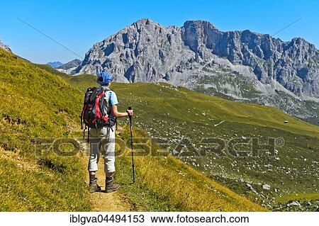 Hiker in Prättigau, behind the summits Wiss Platte and Schijenflue, St. Antönien, Prättigau, Canton of Grisons, Switzerland, Europe View Large Photo Image Stock Image - Hiker in Prättigau, behind the summits Wiss Platte and Schijenflue, St. Antönien, Prättigau, Canton of Grisons, Switzerland, Europe. Fotosearch