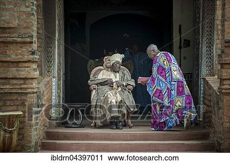 His Majesty, El Hadj Ibrahim Mbombo Njoya Sultan, King of Bamoun, in front of the palace entrance, during a consultation with a tributary, Foumbam, West Region, Cameroon, Africa View Large Photo Image Stock Image - His Majesty, El Hadj Ibrahim Mbombo Njoya Sultan, King of Bamoun, in front of the palace entrance, during a consultation with a tributary, Foumbam, West Region, Cameroon, Africa. Fotosearch