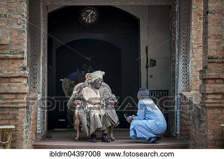 His Majesty, El Hadj Ibrahim Mbombo Njoya Sultan, King of Bamoun, in front of the palace entrance, during a consultation with a tributary, Foumbam, West Region, Cameroon, Africa View Large Photo Image Stock Photo - His Majesty, El Hadj Ibrahim Mbombo Njoya Sultan, King of Bamoun, in front of the palace entrance, during a consultation with a tributary, Foumbam, West Region, Cameroon, Africa. Fotosearch