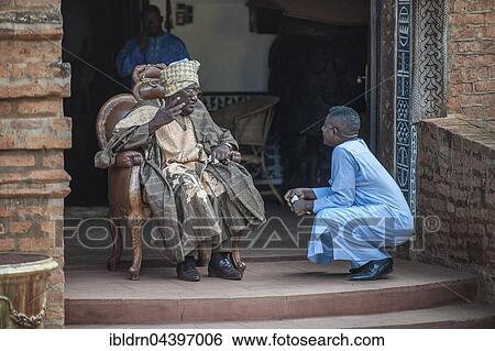 His Majesty, El Hadj Ibrahim Mbombo Njoya Sultan, King of Bamoun, in front of the palace entrance, during a consultation with a tributary, Foumbam, West Region, Cameroon, Africa View Large Photo Image Stock Photograph - His Majesty, El Hadj Ibrahim Mbombo Njoya Sultan, King of Bamoun, in front of the palace entrance, during a consultation with a tributary, Foumbam, West Region, Cameroon, Africa. Fotosearch
