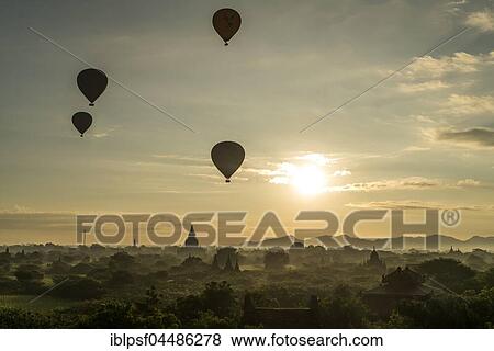 Hot air balloons at sunrise over temples and pagodas, Bagan, Mandalay, Myanmar, Asia View Large Photo Image Stock Photo - Hot air balloons at sunrise over temples and pagodas, Bagan, Mandalay, Myanmar, Asia. Fotosearch