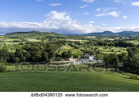 Stock Photography - Hot springs of Saturnia Therme in typical green Tuscany landscape with hills, Saturnia, Tuscany, Italy, Europe. Fotosearch