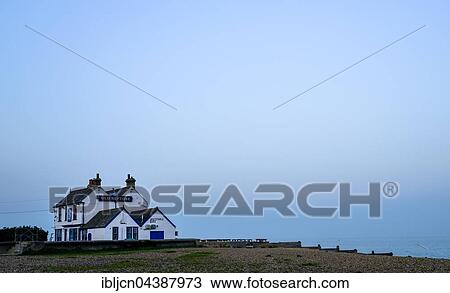 Stock Image - House on the beach in Whitstable, Kent, England, United Kingdom, Europe. Fotosearch