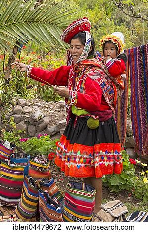 Indigenous mother in traditional costume, spinning, toddler, Maras, Cusco Province, Peru, South America View Large Photo Image Stock Image - Indigenous mother in traditional costume, spinning, toddler, Maras, Cusco Province, Peru, South America. Fotosearch