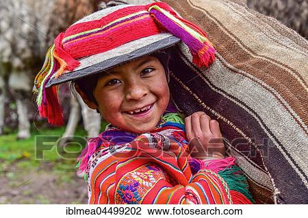 Indio Boy in traditional costume with poncho and hat, carrying bag, near Cusco, Andes, Peru, South America View Large Photo Image Stock Image - Indio Boy in traditional costume with poncho and hat, carrying bag, near Cusco, Andes, Peru, South America. Fotosearch