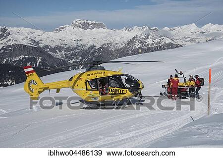 Injured skier is transported by snowmobile in rescue helicopter ÖAMTC, Silvretta Montafon, Kapellalpe, village of Schruns, Montafon, Vorarlberg, Austria, Europe View Large Photo Image Stock Photo - Injured skier is transported by snowmobile in rescue helicopter ÖAMTC, Silvretta Montafon, Kapellalpe, village of Schruns, Montafon, Vorarlberg, Austria, Europe. Fotosearch