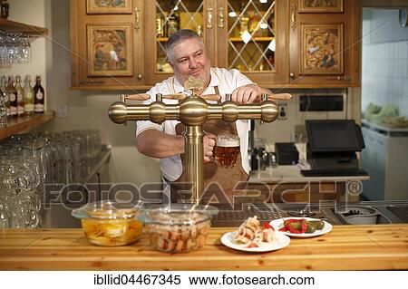 Innkeeper, waiter, dispensing beer, pub, beer pump, Karlovy Vary, Czech Republic, Europe View Large Photo Image Stock Photography - Innkeeper, waiter, dispensing beer, pub, beer pump, Karlovy Vary, Czech Republic, Europe. Fotosearch