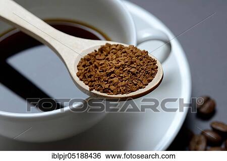 Instant coffee in spoon on coffee cup, Coffea arabica View Large Photo Image Stock Photograph - Instant coffee in spoon on coffee cup, Coffea arabica. Fotosearch