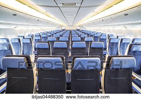 Stock Image - Interior of big airplane with seats. Fotosearch