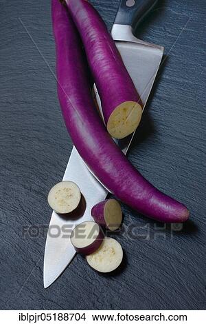 Picture - Japanese eggplant with knife, Solanum melongena, Solanum melongina. Fotosearch