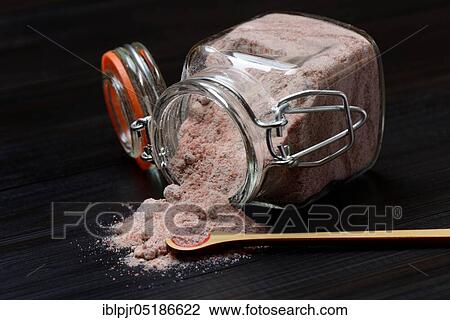 Stock Image - Kala Namak, ground salt in glass container and spoon, Indian salt, black salt, black salt, India, Asia. Fotosearch