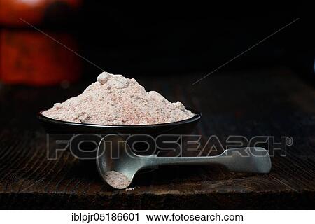 Stock Image - Kala Namak, ground salt with spoon in bowl, Indian salt, black salt, black salt, India, Asia. Fotosearch