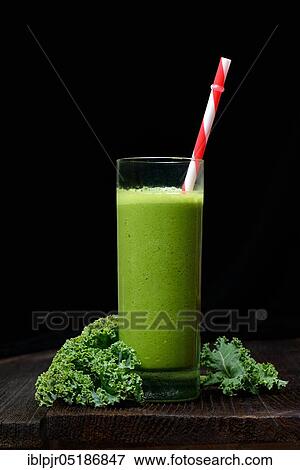 Stock Photo - Kale smoothie in glass with drinking straw, smoothie, kale, curly kale, kale with feathers, winter kale ( Brassica oleracea) acephala var. sabellica. Fotosearch