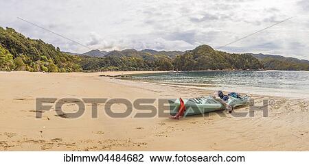 Stock Image - Kayak lying on the beach, Anchorage Bay, Abel Tasman National Park, Tasman Region, Southland, New Zealand, Oceania. Fotosearch