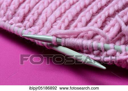 Stock Image - Knitted wool with knitting needles, wool, felting wool, do-it-yourself, knitting. Fotosearch