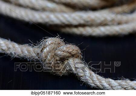 Stock Image - Knots in jute rope, intertwined, knotted. Fotosearch
