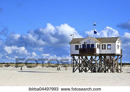Stock Image - Lake dwelling on the beach against a blue sky with cumulus clouds, Sankt Peter-Ording, Schleswig-Holstein Wadden Sea National Park, North Frisia, Schleswig-Holstein, Germany, Europe. Fotosearch