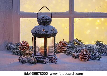 Stock Image - Lantern with Christmas decoration on windowsill. Fotosearch