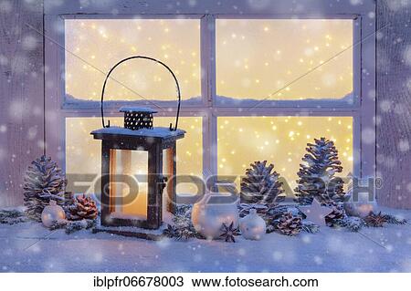 Stock Image - Lantern with Christmas decoration on windowsill. Fotosearch