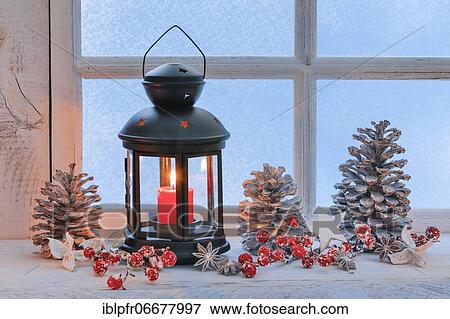 Lantern with Christmas decoration on windowsill View Large Photo Image Stock Photo - Lantern with Christmas decoration on windowsill. Fotosearch