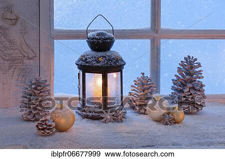 Stock Photo - Lantern with Christmas decoration on windowsill. Fotosearch
