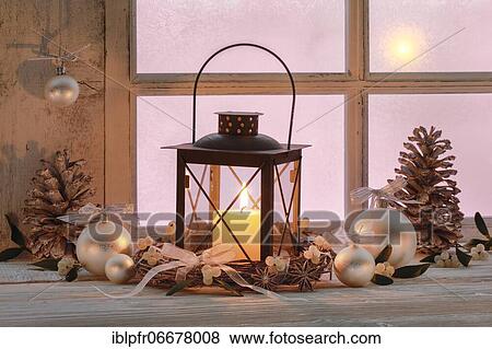 Stock Photo - Lantern with Christmas decoration on windowsill. Fotosearch
