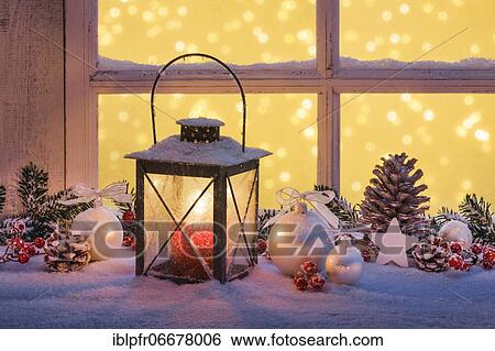 Stock Photograph - Lantern with Christmas decoration on windowsill. Fotosearch