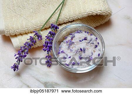 Stock Image - Lavender salt, sea salt with lavender flowers in a bowl, bath additive. Fotosearch