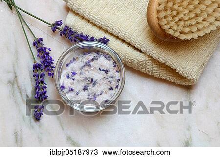 Stock Image - Lavender salt, sea salt with lavender flowers in a bowl, bath additive. Fotosearch